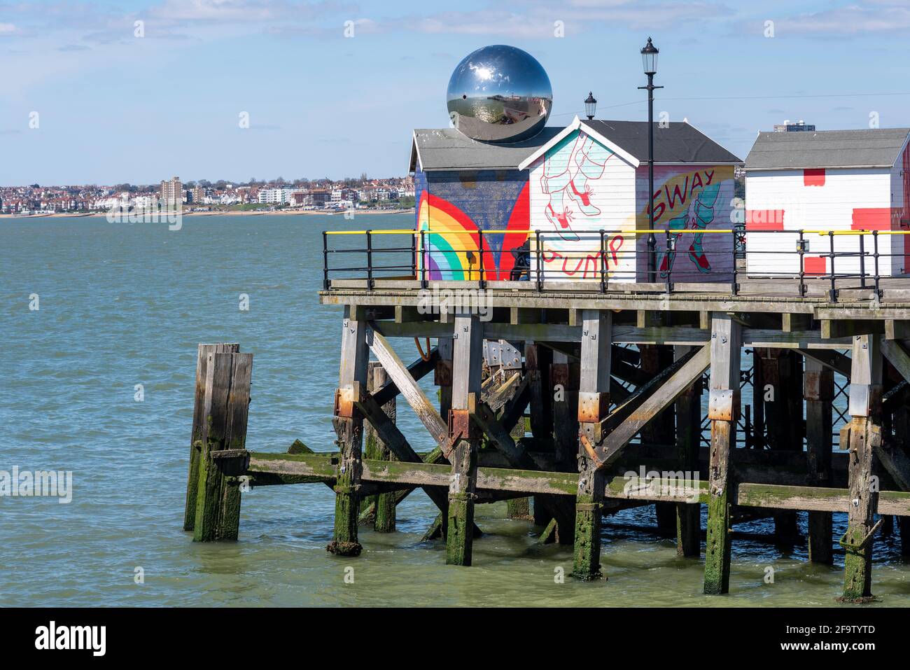 Brightly coloured huts on the end of Southend Pier, with a mirror ball reflecting the sunny surroundings. Southend on Sea, Essex, UK resort on Thames Stock Photo