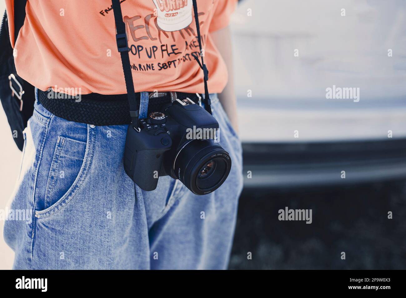 No face photo of young skinny girl with a camera on a belt  Stock Photo
