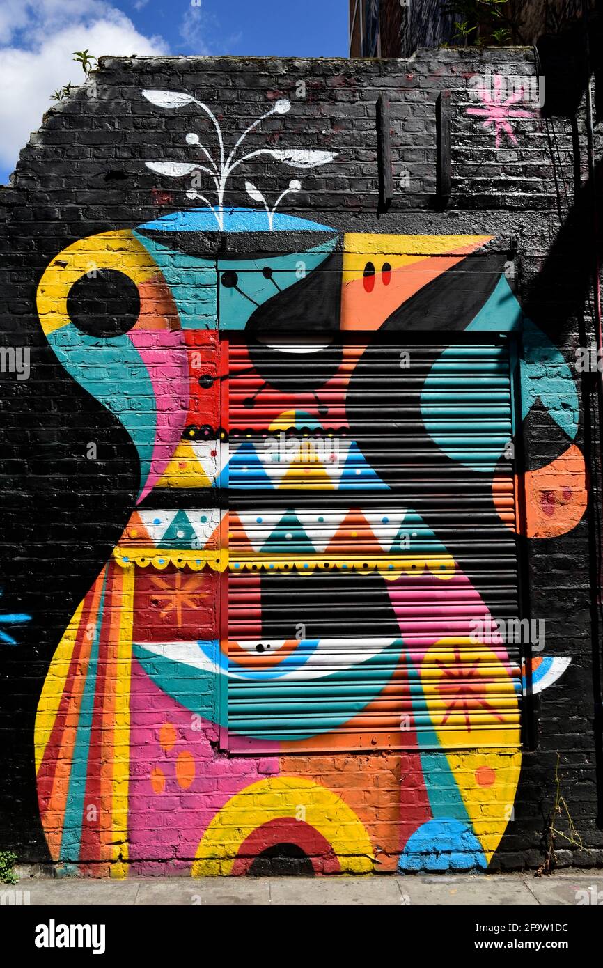 Tourists viewing street art in Shoreditch.