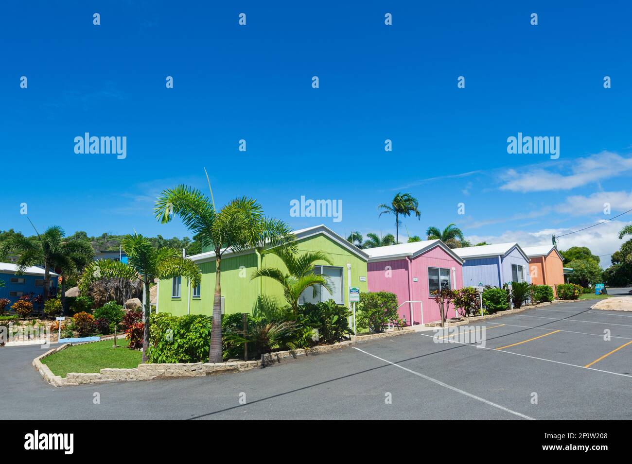Row of beach cabins painted in pastel colours at Horseshoe Bay Resort, Bowen, Queensland, QLD, Australia Stock Photo
