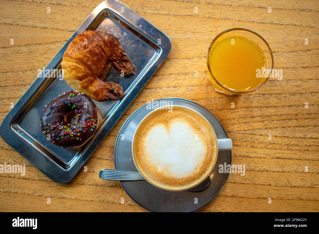 Coffee with milk with donut and butter croissant. Stock Photo