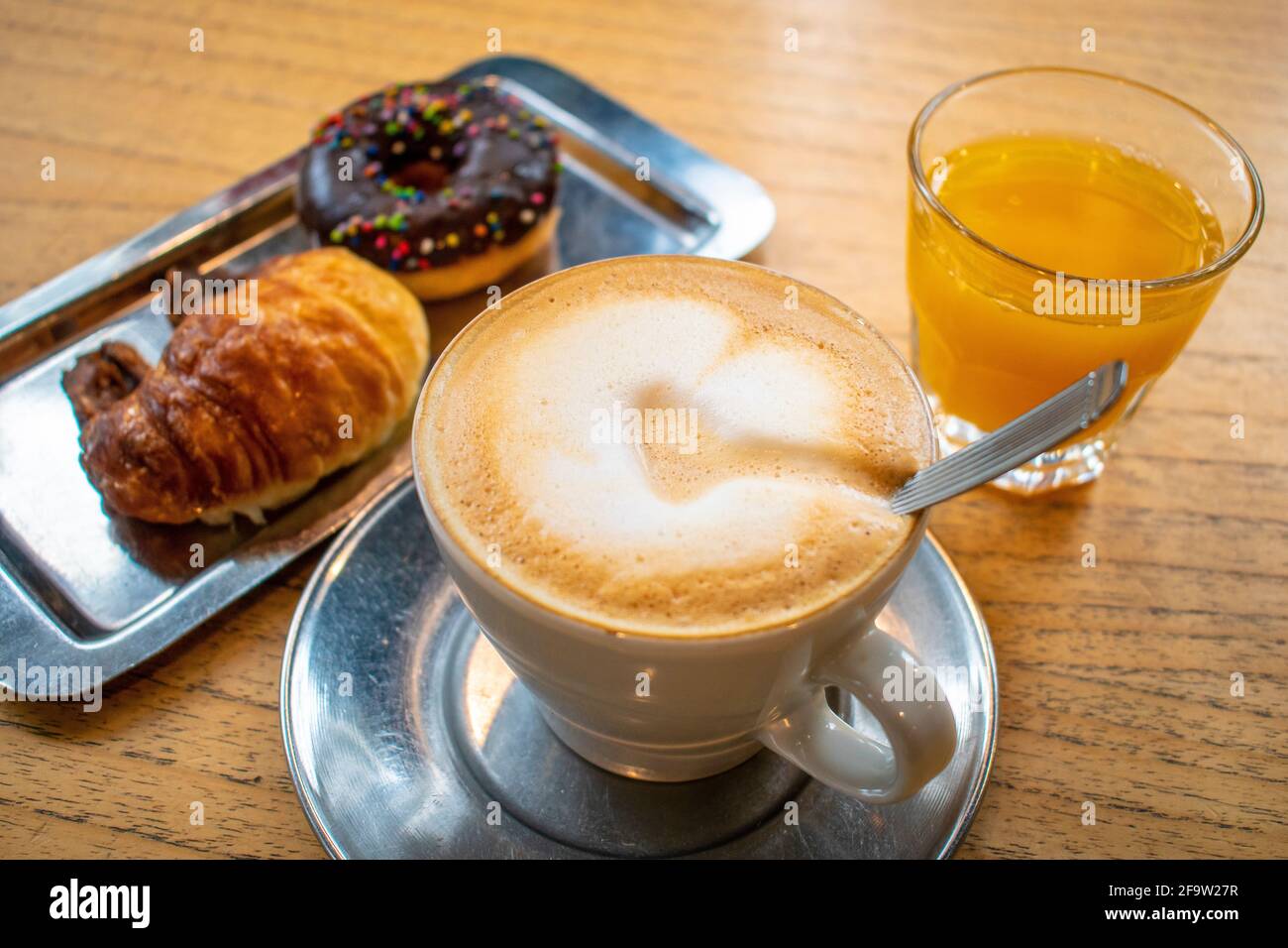 Coffee with milk with donut and butter croissant. Stock Photo