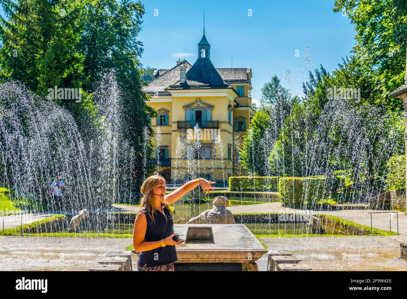 HELLBRUNN, AUSTRIA, JULY 30, 2016: A guide is introducing visitors to a trick fountain in the Hellbrunn Palace in Salzburg, Austria. Stock Photo