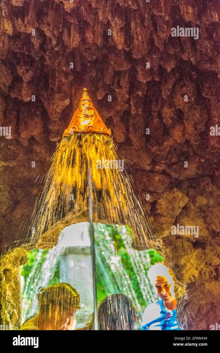 HELLBRUNN, AUSTRIA, JULY 30, 2016: People are being surprised by a water attack committed by a trick fountain in the Hellbrunn Palace in Salzburg, Aus Stock Photo