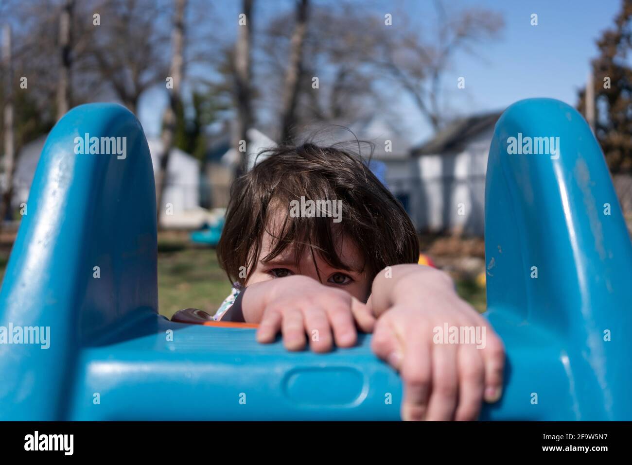 A toddler girl playing outside Stock Photo