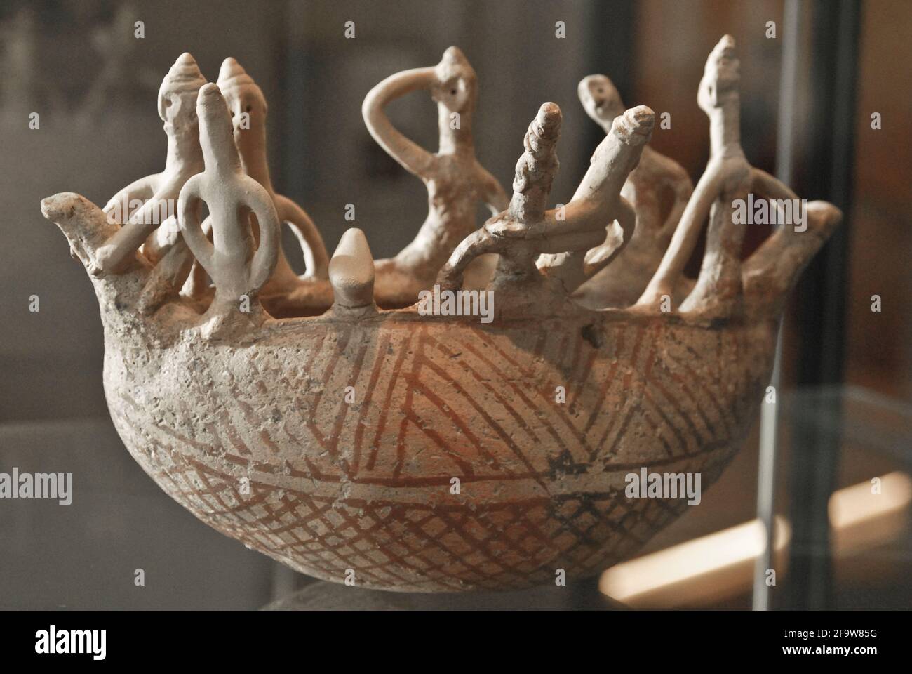 Ancient vase with human figures. Mesopotamian art. Louvre Museum Stock Photo