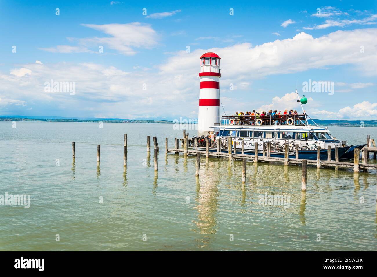 PODERSDORF AM SEE, AUSTRIA, JUNE 17, 2016:people are entering a ferry boat in podersdorf am see town situated next to neusiedlersee in austria. Stock Photo