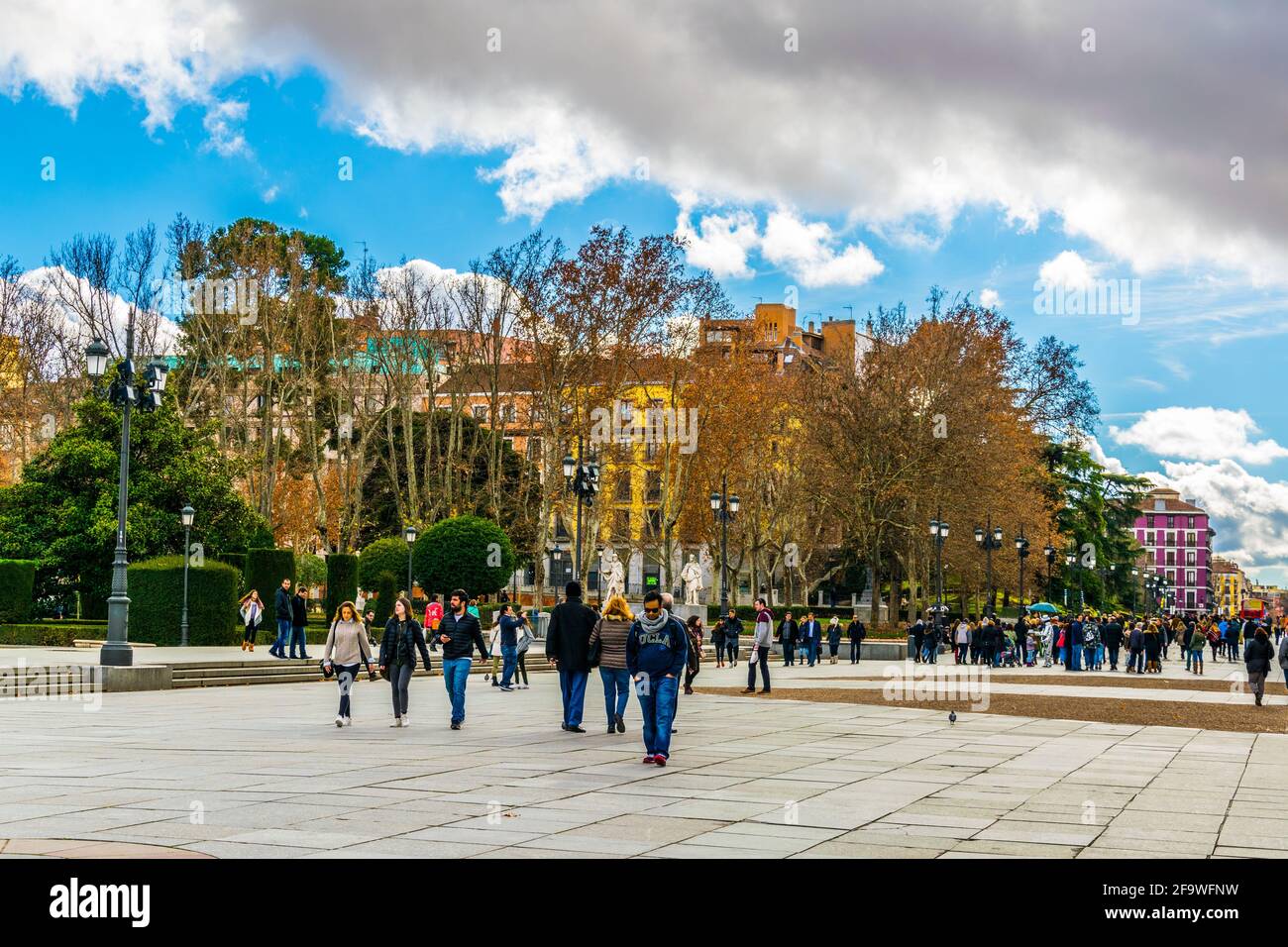 MADRID, SPAIN, JANUARY 9, 2016: People are walking on a street next to the royal palace in madrid Stock Photo