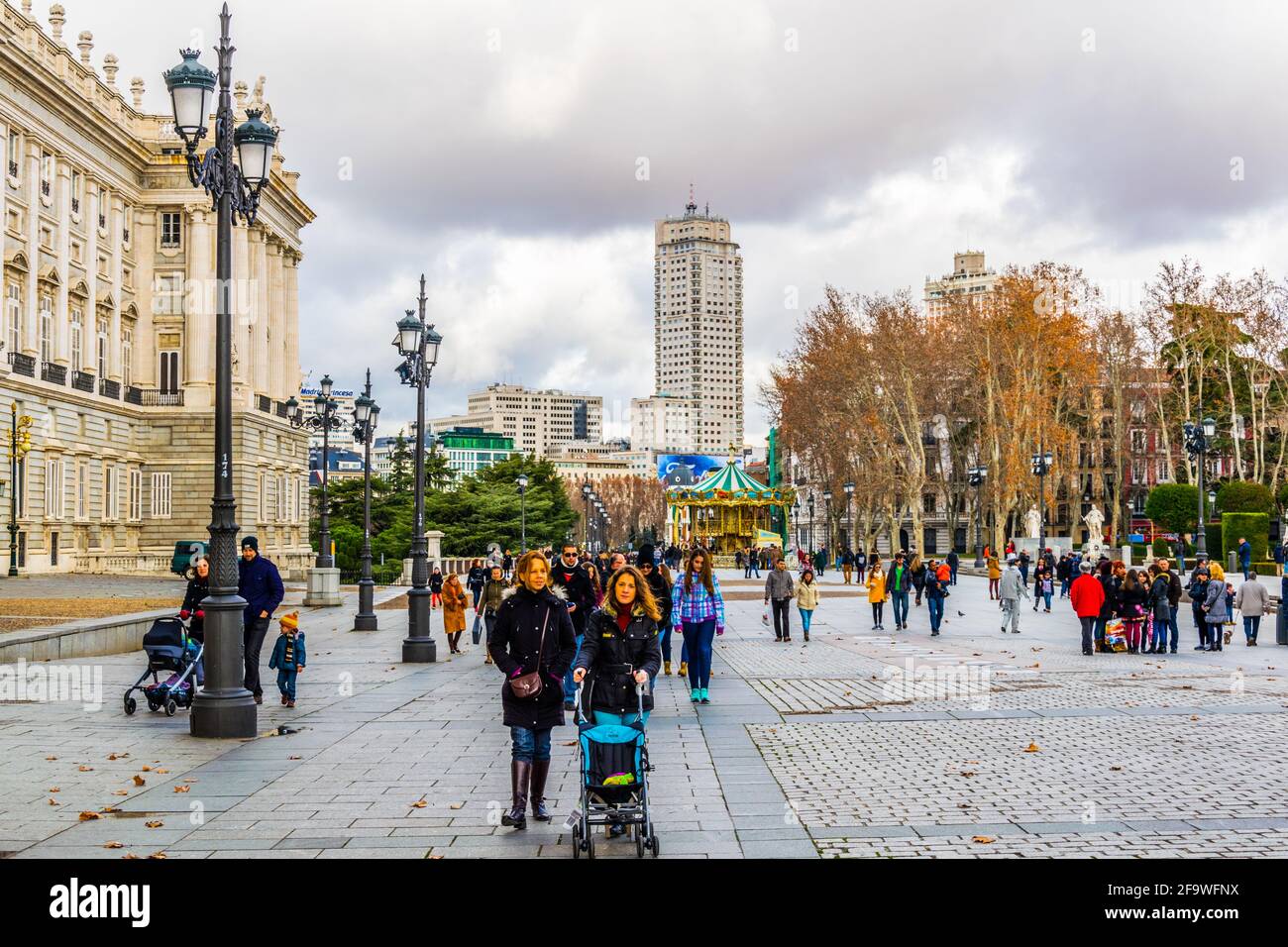 MADRID, SPAIN, JANUARY 9, 2016: People are walking on a street next to the royal palace in madrid Stock Photo