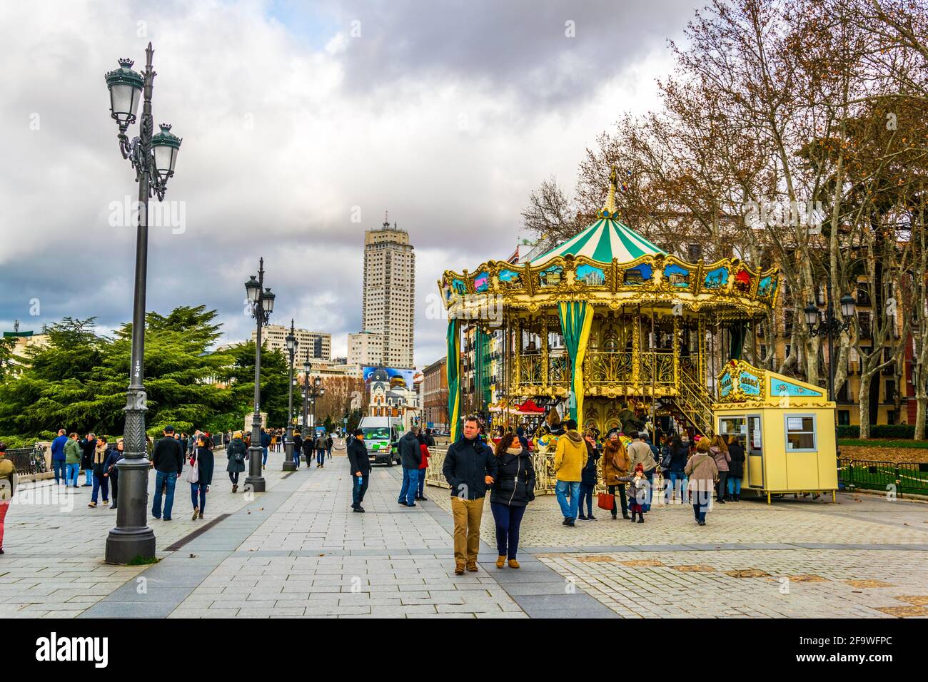 MADRID, SPAIN, JANUARY 9, 2016: People are walking on a street next to the royal palace in madrid Stock Photo