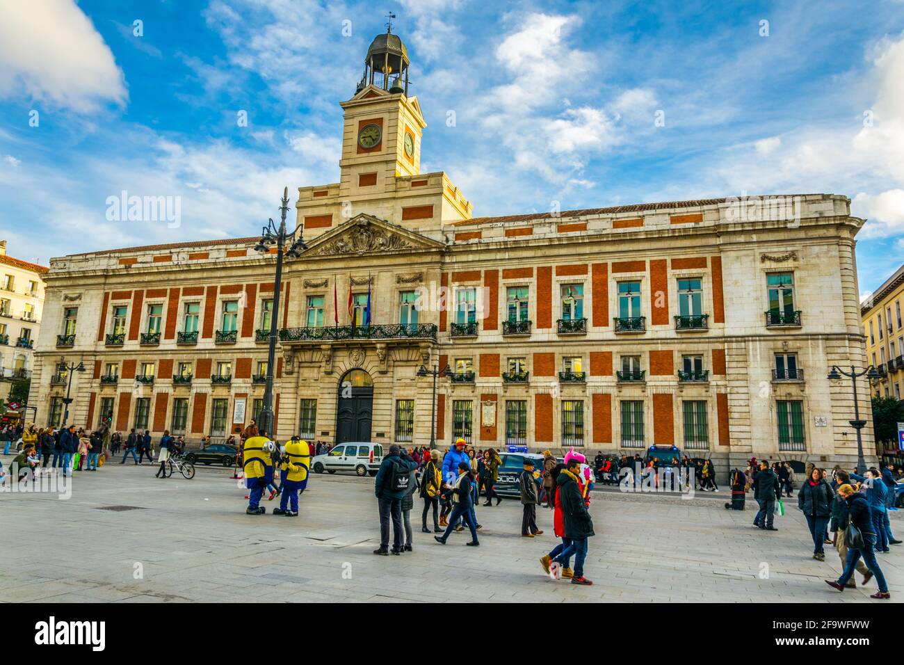 MADRID, SPAIN, JANUARY 9, 2016: People are strolling in front of the Old Post Office building, currently the seat of the Presidency of the Madrid Comm Stock Photo