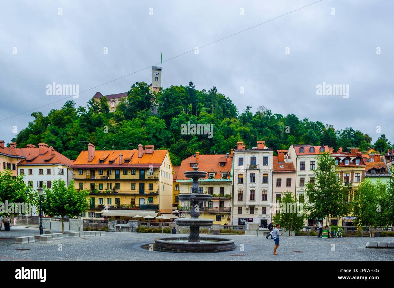 LJUBLJANA, SLOVENIA, JULY 29, 2015: Novi trg - New city square in the slovenian capital Ljubljana is overlooked by a castle situated on a hill across Stock Photo