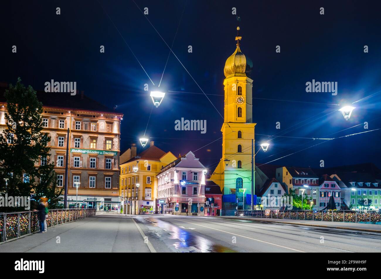 GRAZ, AUSTRIA - JANUARY 7, 2015: night view of a bridge leading to the Franciscan church in Graz in Austria Stock Photo