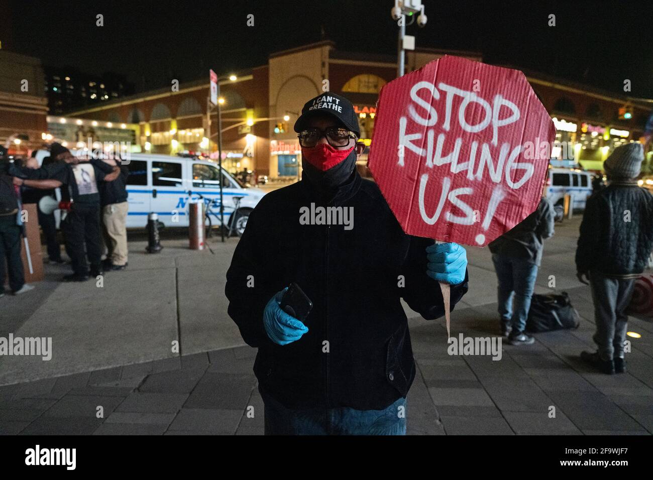 Brooklyn, New York, USA 20 Apr 2021. Man holds 'Stop Killing Us' sign as protesters gather at Barclays Center hours after a jury found former Minneapolis police officer Derek Chauvin guilty of murdering George Floyd in 2020. Stock Photo