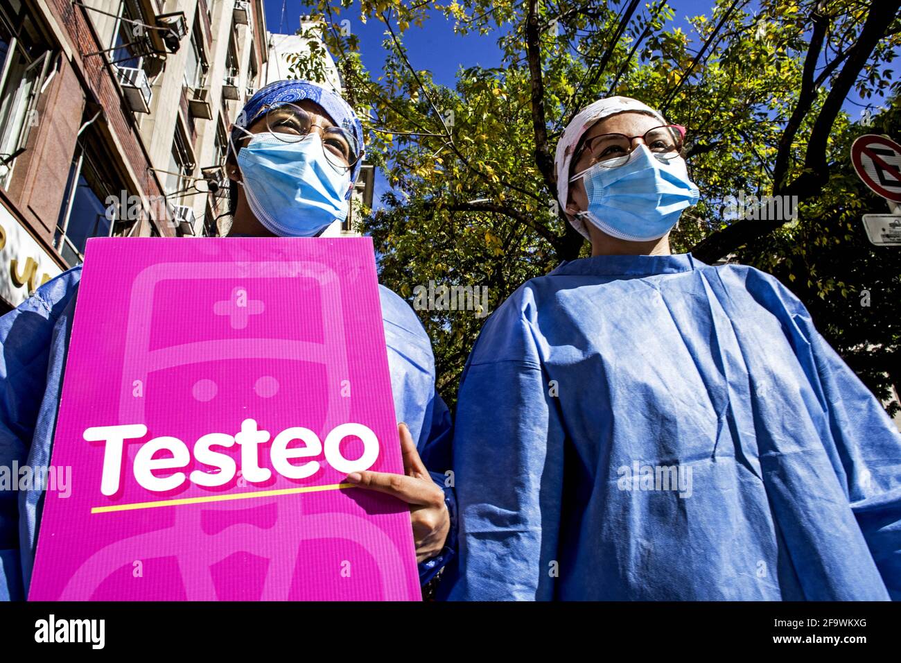 Buenos Aires, Federal Capital, Argentina. 20th Apr, 2021. In the photograph, two health workers walk the streets inviting people to take a rapid test that determines, in 20 minutes, the existence or not of the coronavirus. One of them holds a sign that reads ''Testeo''.The Ministry of Health report confirmed 29,145 new infections in the last 24 hours, a much higher number than yesterday, confirming the consolidation of the second wave of coronavirus in the country. These records bring the total number of cases to 2,743,620 since the beginning of the pandemic. In addition, 316 new deaths of co Stock Photo