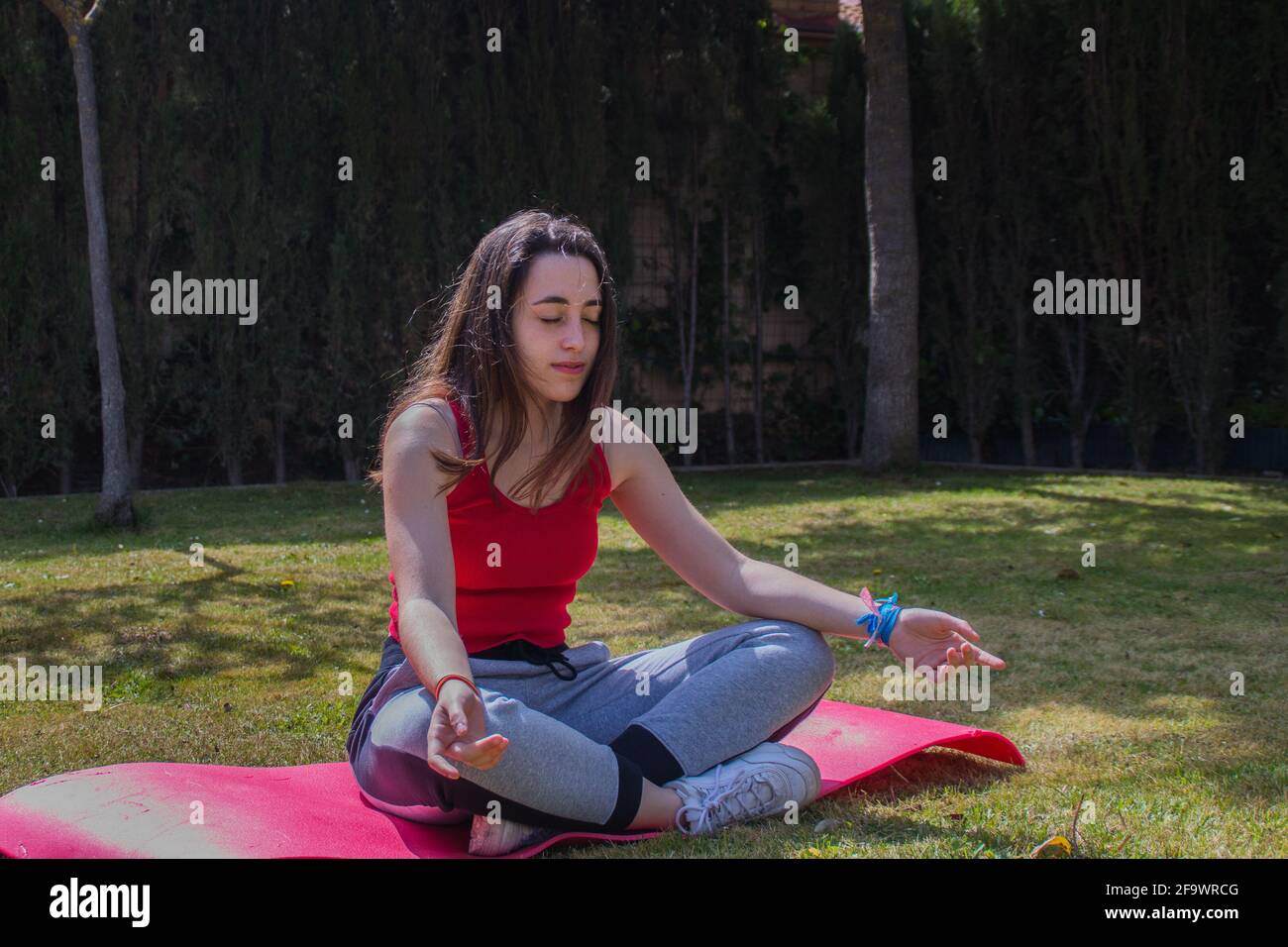 Young caucasian girl practising yoga in the lotus position Stock Photo ...