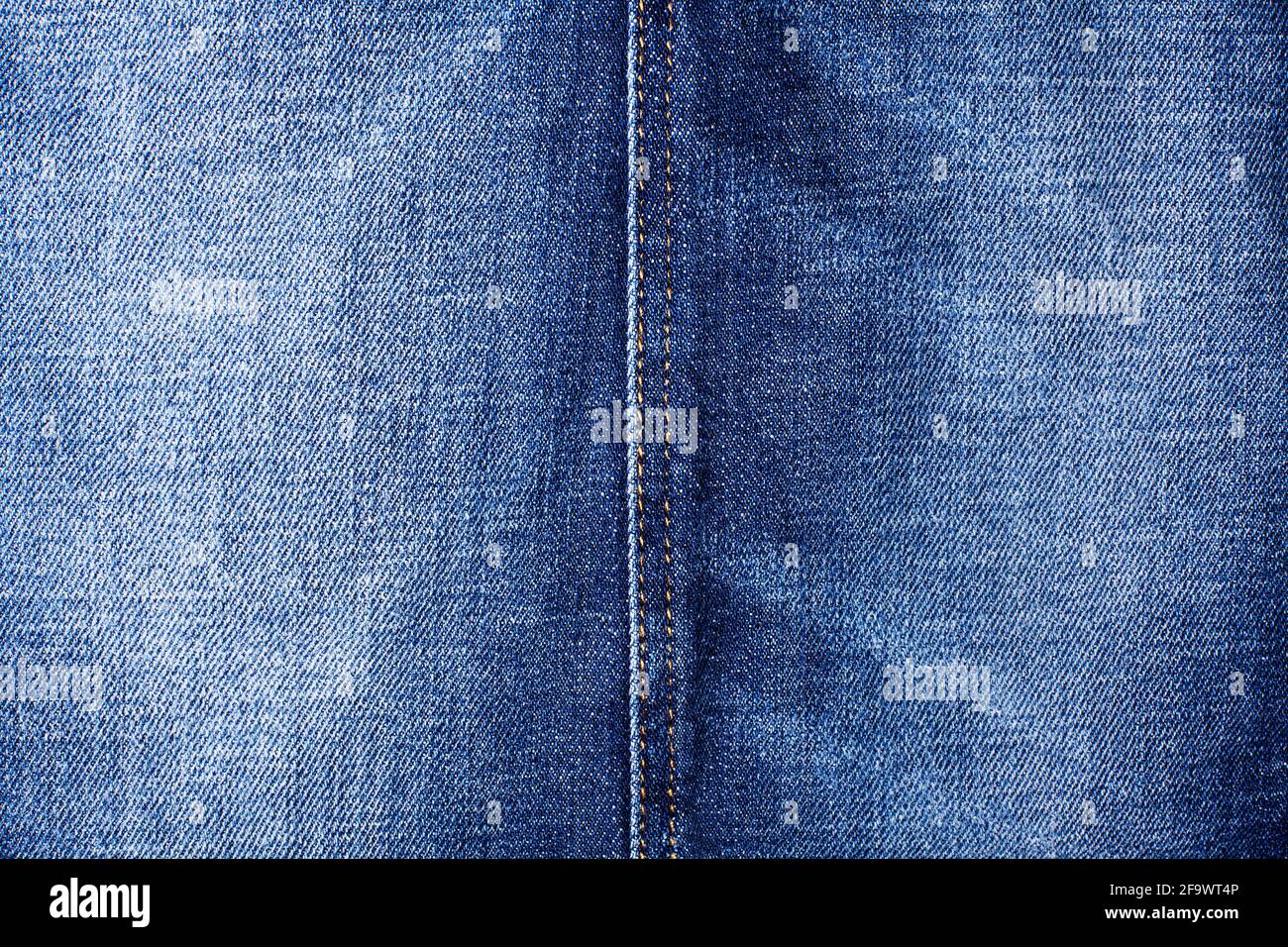 Blue jeans texture and seam close up, thread stitch line, jean textile background, blue denim backdrop, faded jeans pattern, shabby indigo jeans cloth Stock Photo