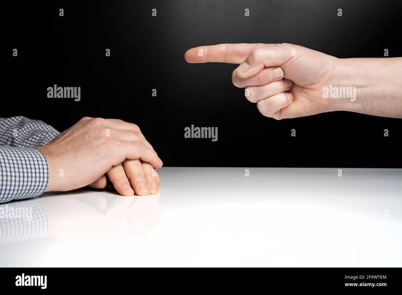 one man points his finger to another man in front Stock Photo