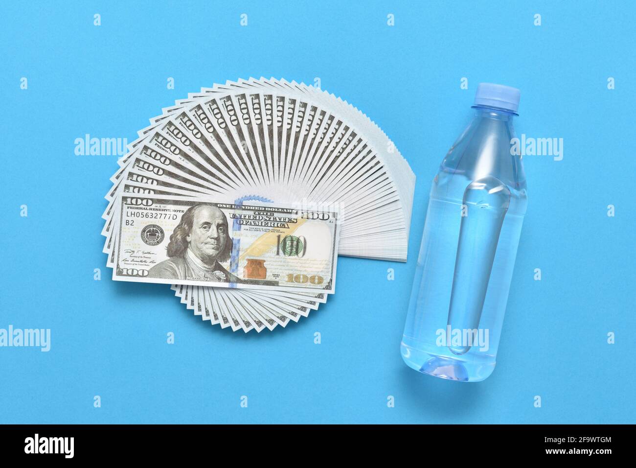 Water bottle and dollar bills Stock Photo Alamy