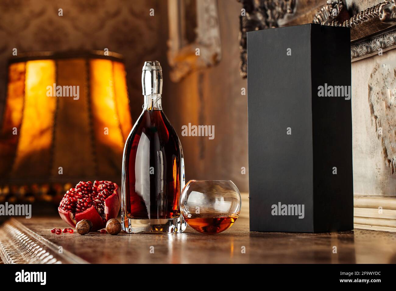 Elegant bottle of cognac with appetizers Stock Photo