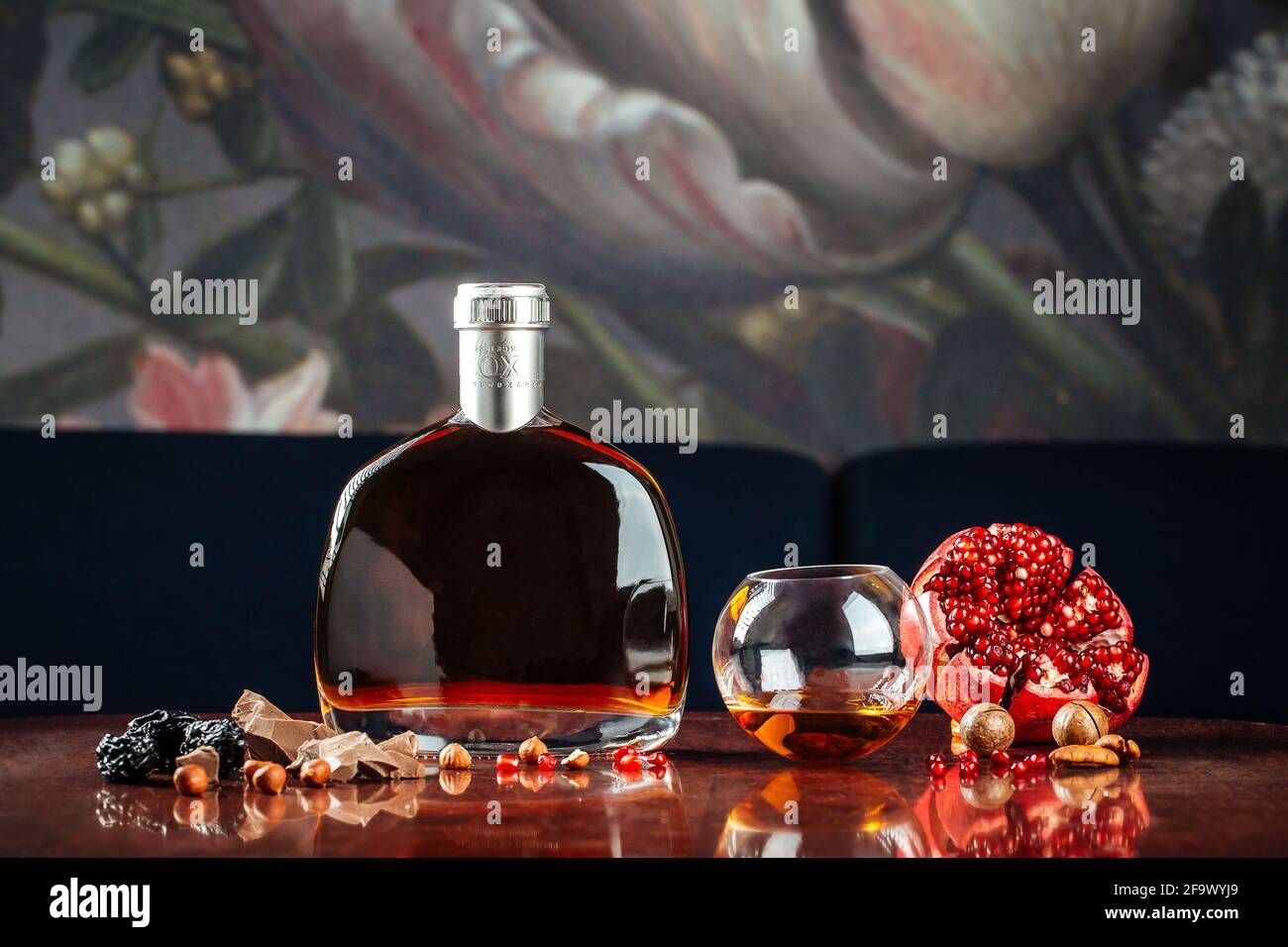 Elegant bottle of cognac with appetizers Stock Photo