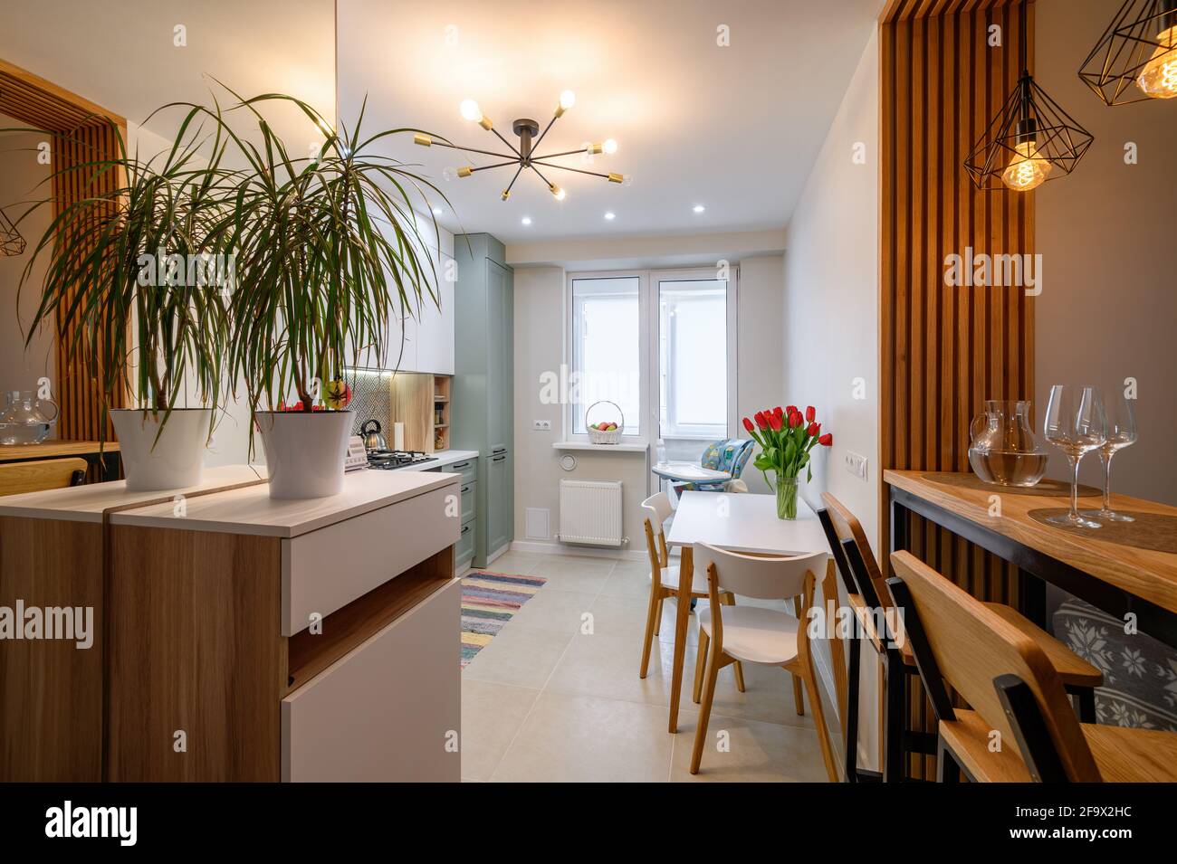 Modern classic white kitchen interior with dining zone Stock Photo - Alamy