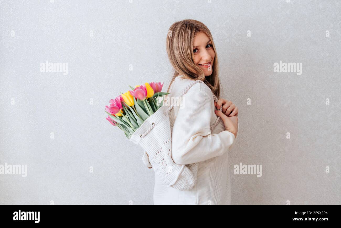 Woman with bag of tulips flowers. Stock Photo