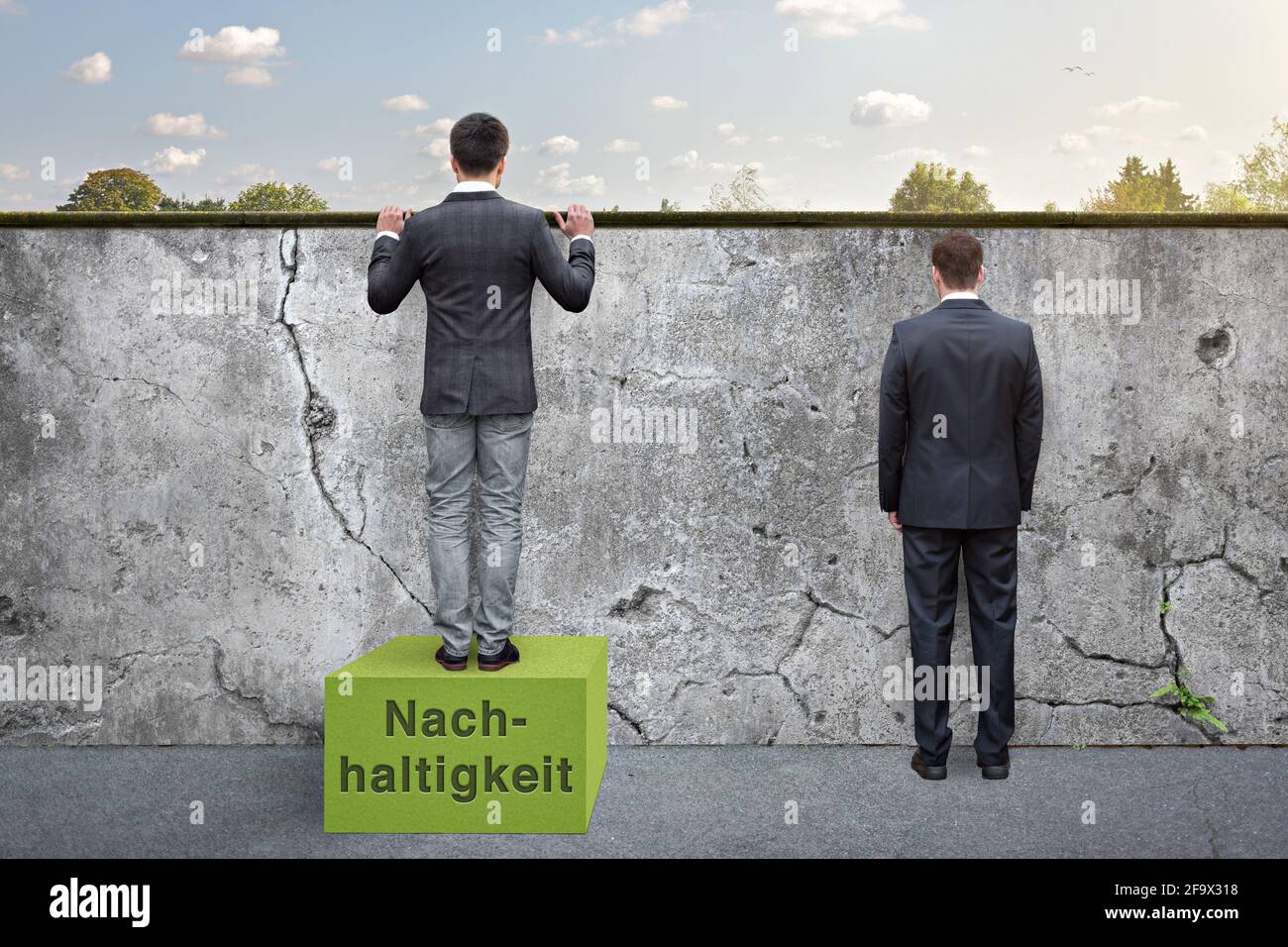 Clever man building on sustainability - awareness metaphor (Nachhaltigkeit = German for sustainability) Stock Photo