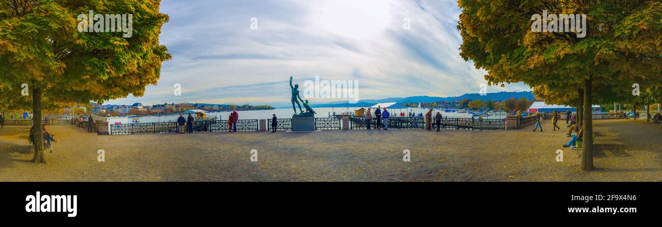 ZURICH, SWITZERLAND, OCTOBER 24, 2015: People are admiring zurich lake from the viewpoint with famous ganimede statue Stock Photo