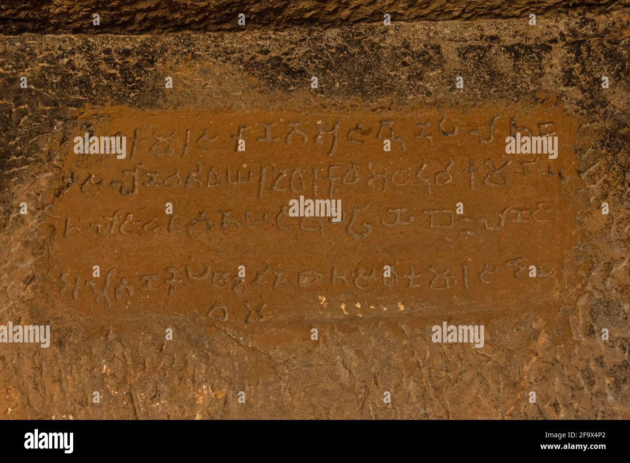 Brahmi Script in Cave 9,  Gandharpale Buddhist caves. Group of 30 Buddhist caves, 105 km south of Mumbai, near Mahad, Maharashtra, India Stock Photo