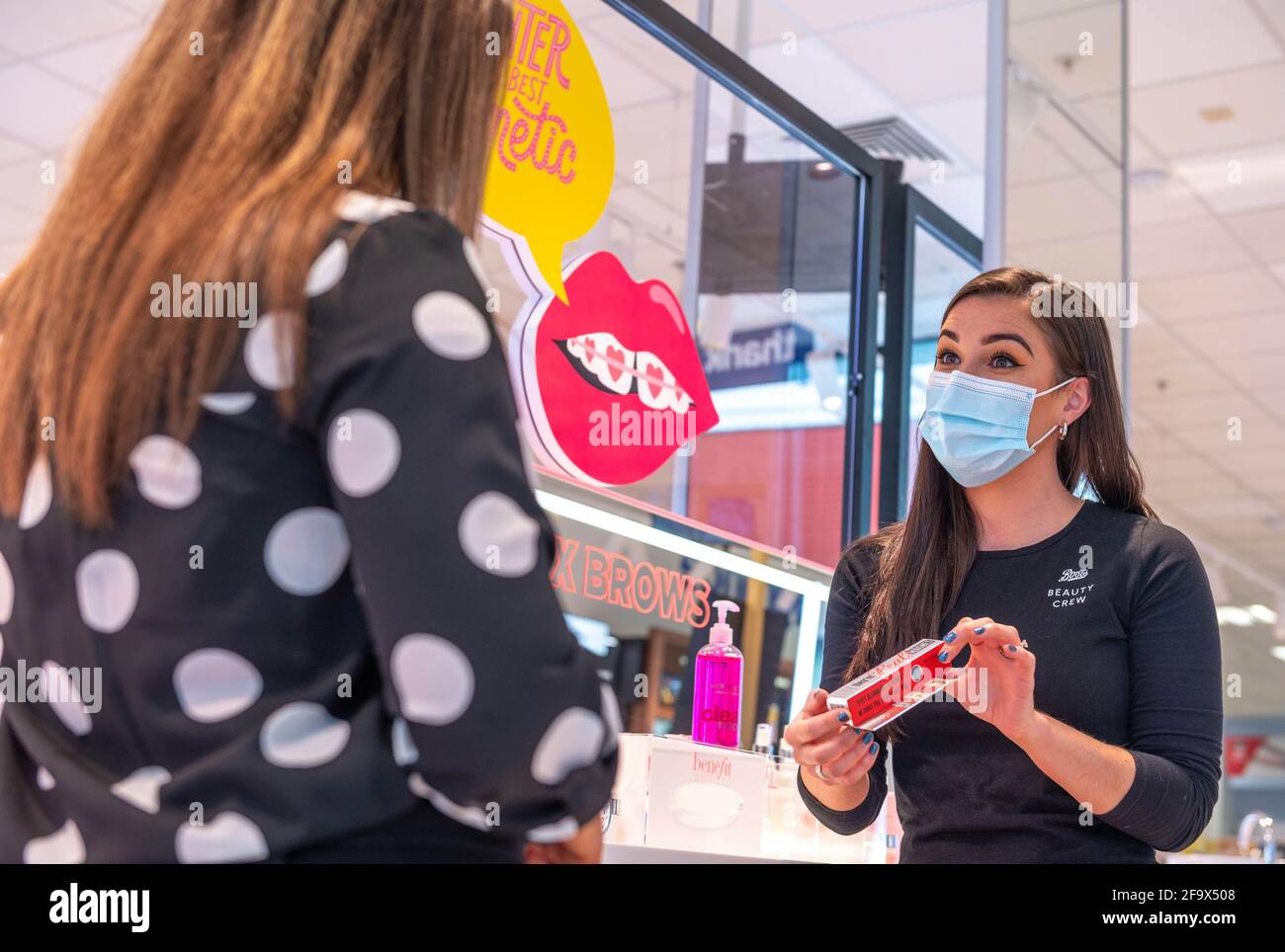 EDITORIAL USE ONLY Jen McCormack, beauty specialist at Boots assists a