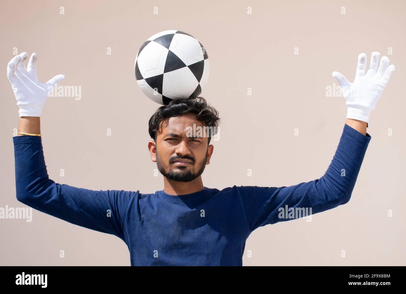 Footballer balancing soccer ball on his head Stock Photo Alamy