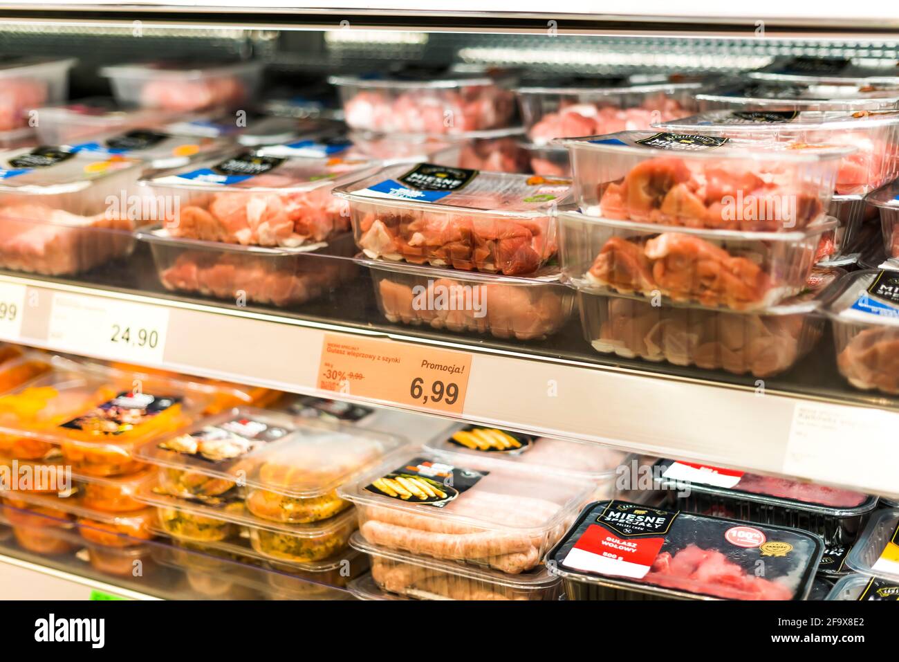 POZNAN, POL - APR 13, 2021: Meat products put up for sale in a supermarket commercial refrigerator Stock Photo