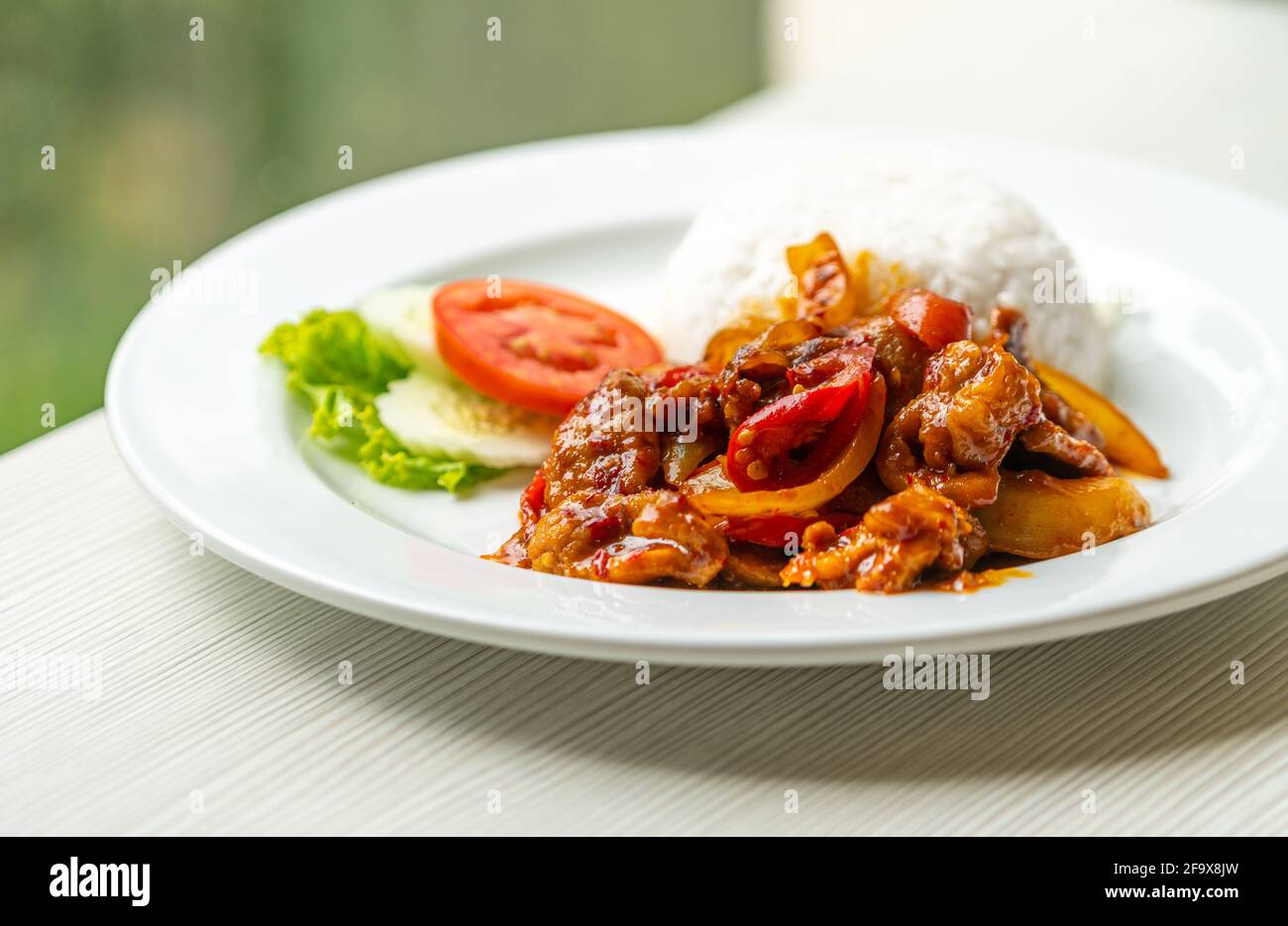 Stirfried pork with traditional Thai Chili Paste or Moo Pad Prickpow in Thailand language with
