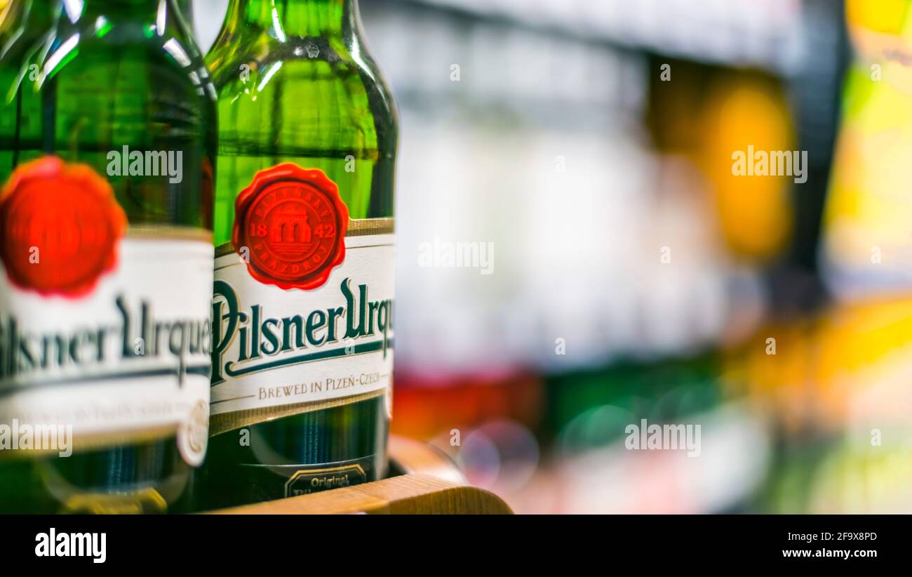 POZNAN, POL - APR 13, 2021: Pilsner Urquell beer put up for sale in a supermarket Stock Photo