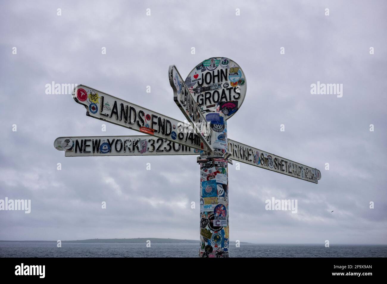 John O'Groats, UK - June 24, 2019: The landmark "Journey's End" signpost at John o' Groats, a popular tourist attraction marking the furthest north on Stock Photo