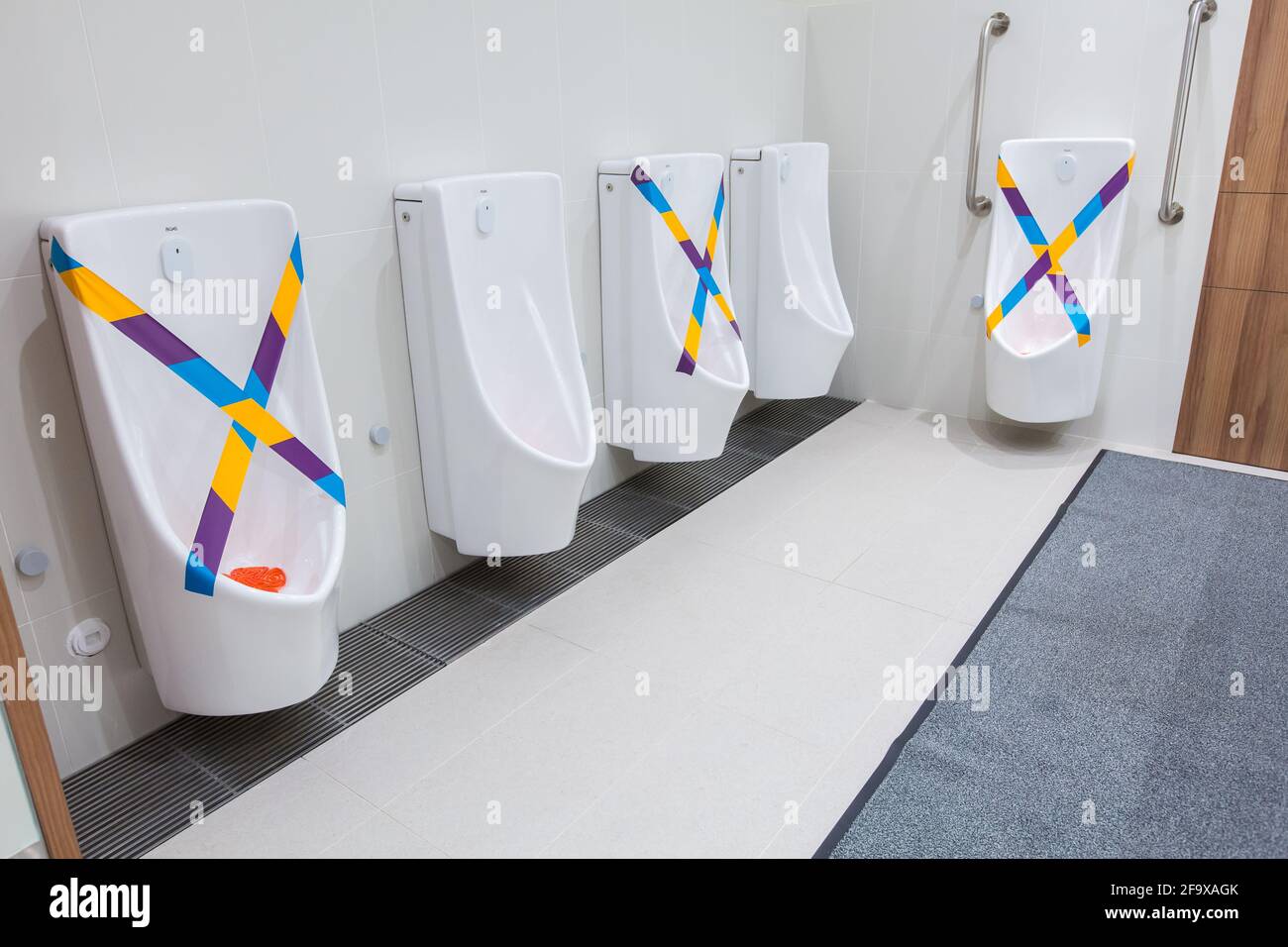 Safe distancing measure implemented in the toilet to reduce physical interaction for the well-being of public safety. Singapore. Stock Photo