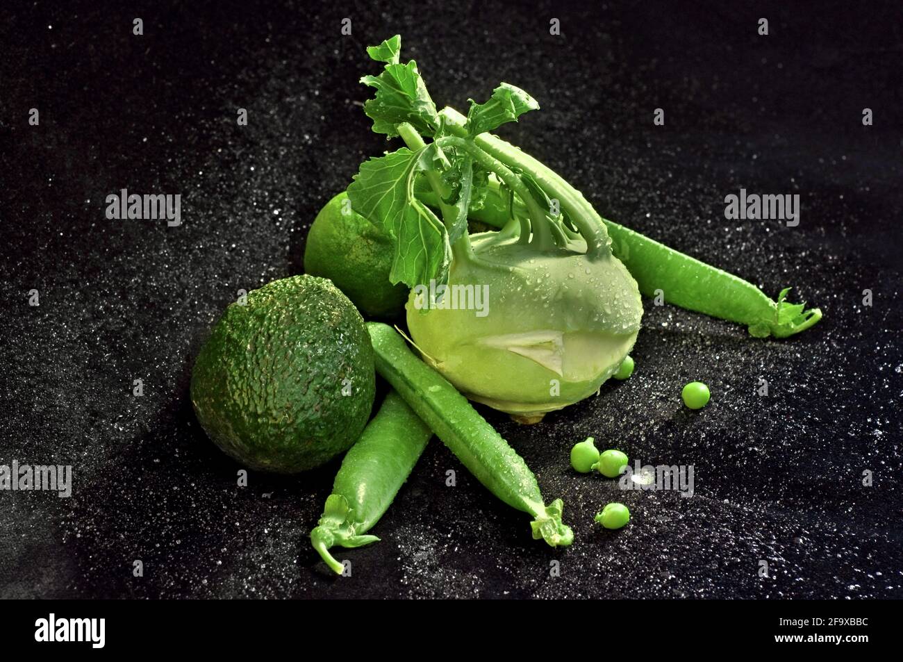 Still life with light green vegetables on black velvet with water drops Stock Photo Alamy