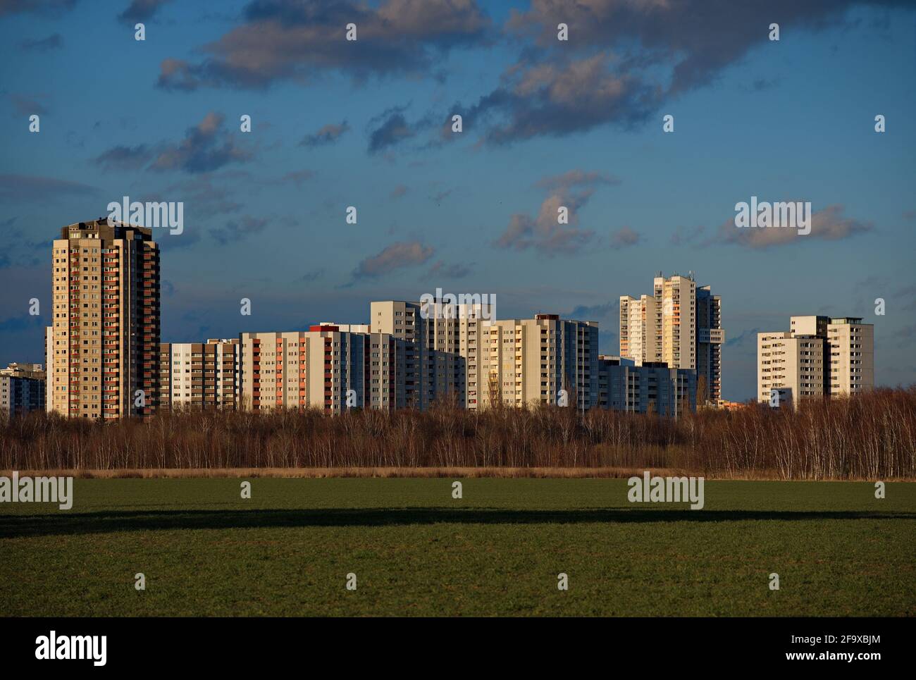 Residential buildings in Berlin, district Gropiusstadt, and a field in Großziethen, state Brandenburg Stock Photo