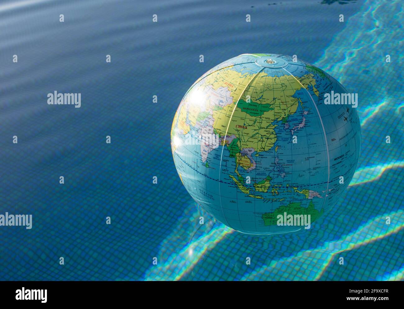 Plastic, inflatable globe floating in a swimming pool. Close up Stock ...