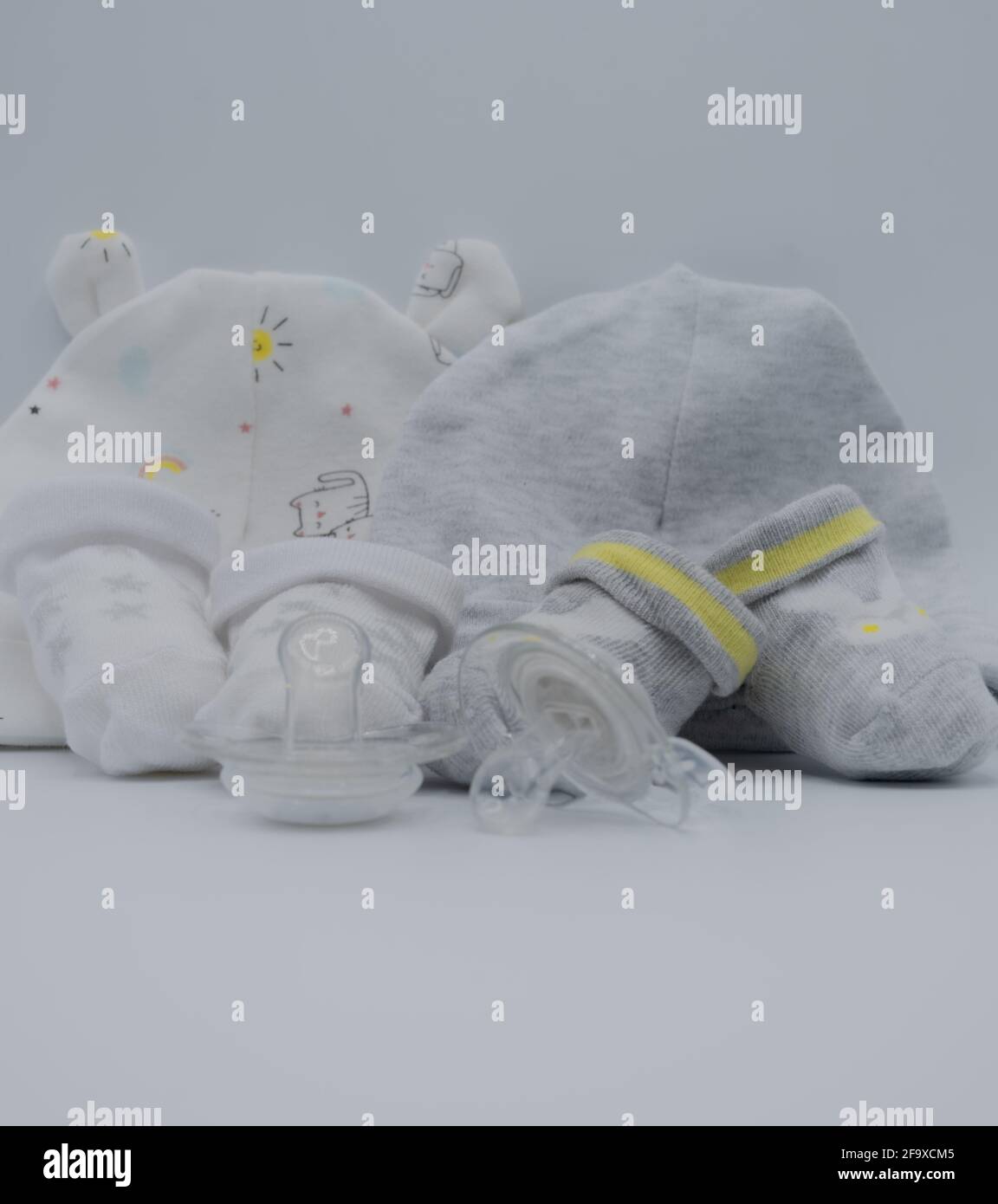 Newborn composition with booties and dummies Stock Photo
