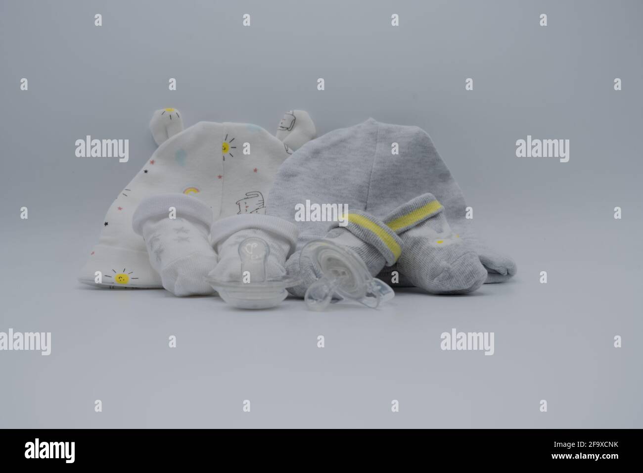 Newborn composition with booties and dummies Stock Photo