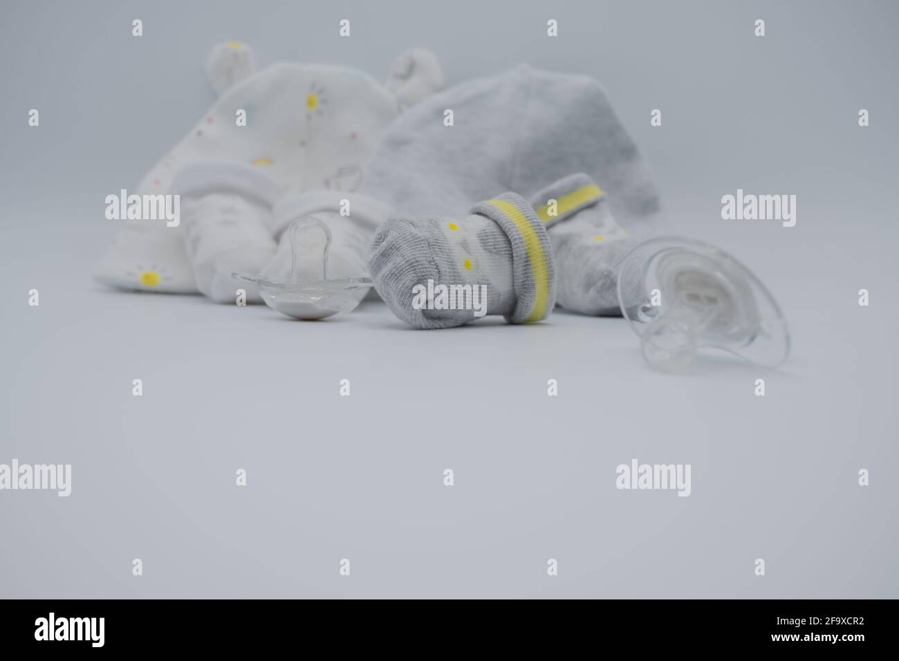 Newborn composition with booties and dummies Stock Photo