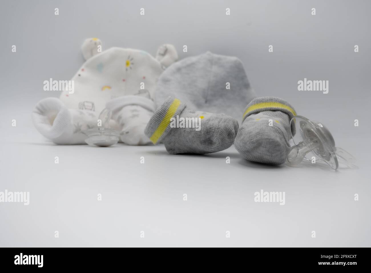Newborn composition with booties and dummies Stock Photo