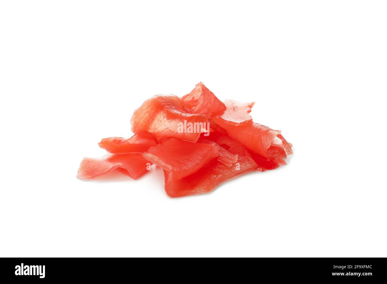 Red pickled ginger isolated on white background. Pile of red pickled ginger slices, Japanese condiment for sushi isolated on white Stock Photo