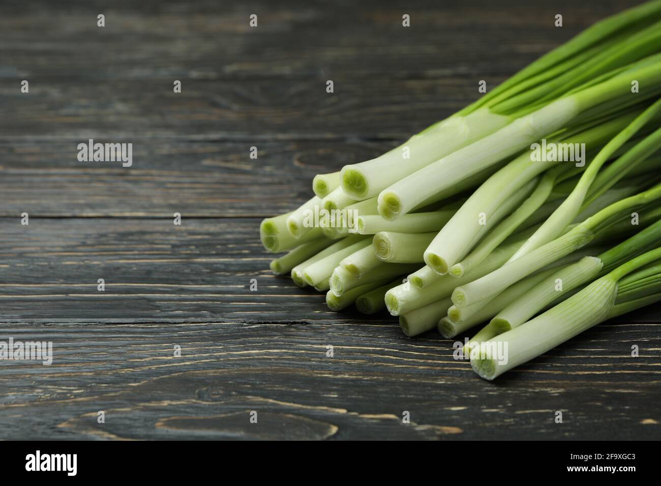 Fresh green onion on wooden table, space for text Stock Photo - Alamy