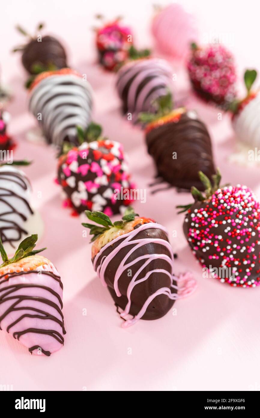Variety of chocolate dipped strawberries on a pink background Stock ...