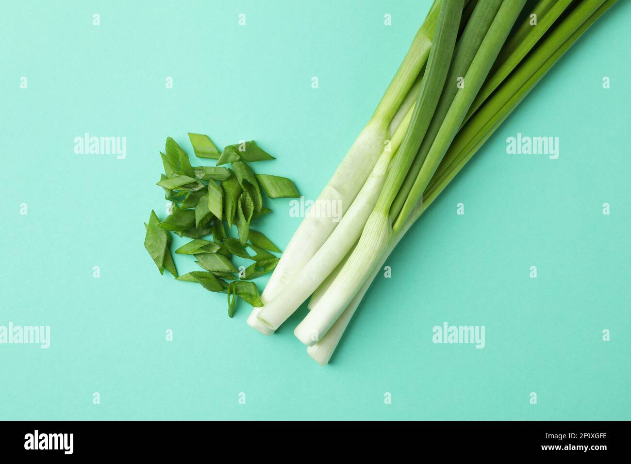 Bunch of green onion on mint background Stock Photo - Alamy