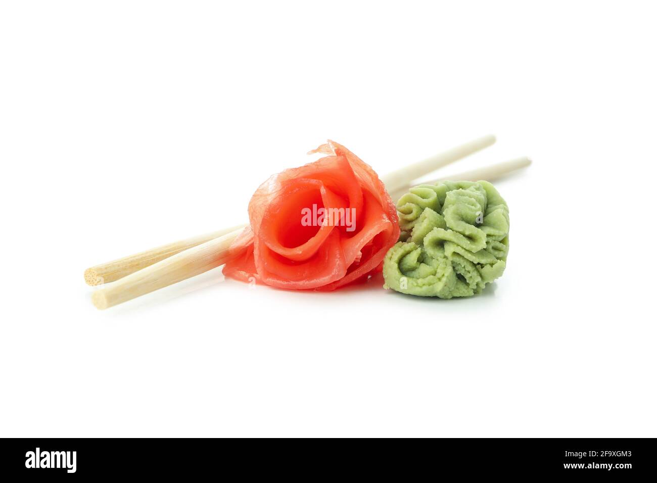Pickled ginger, wasabi and chopsticks isolated on white background