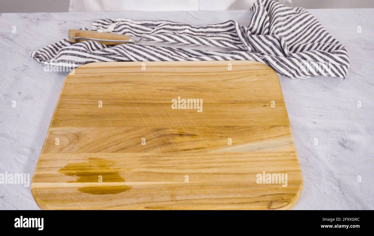 Step by step. Chopping organic green onions on a wood cutting board ...